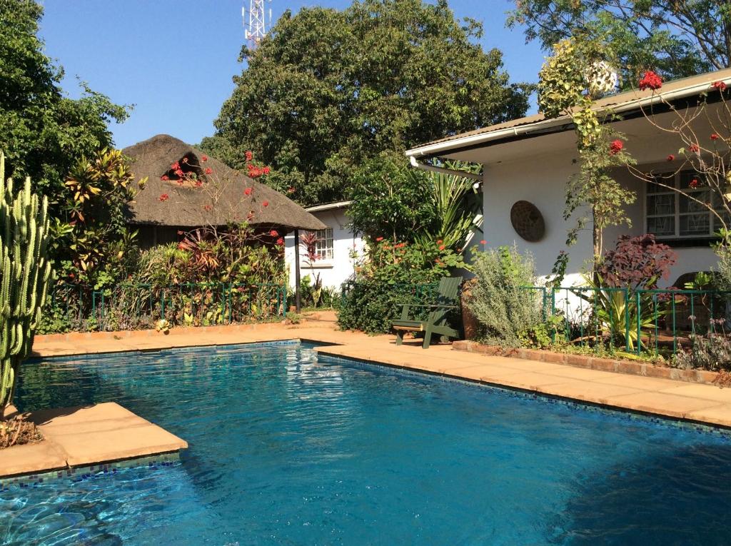 a swimming pool in front of a house at Tabonina Guesthouse in Livingstone