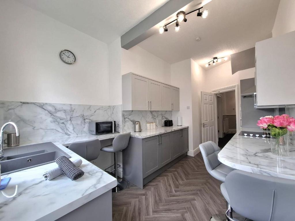 a kitchen with a sink and a counter top at Central Luxury Town House in Blackpool