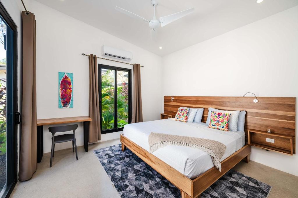 a bedroom with a bed and a desk and a window at Villa Serenity 4 bedroom 1 min walk to the beach in Santa Cruz