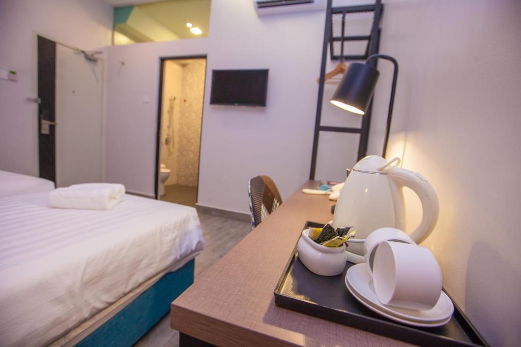 Postel nebo postele na pokoji v ubytování Bzz Hotel Skudai