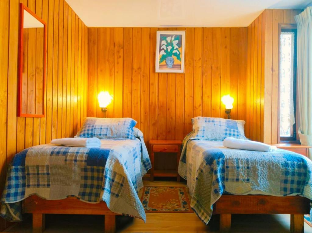Postel nebo postele na pokoji v ubytování Hostal & Cabañas Don Juan