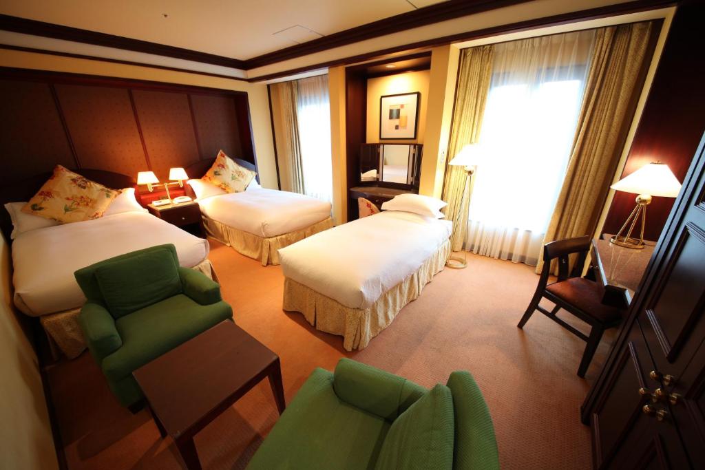 Postel nebo postele na pokoji v ubytování Mito Plaza Hotel