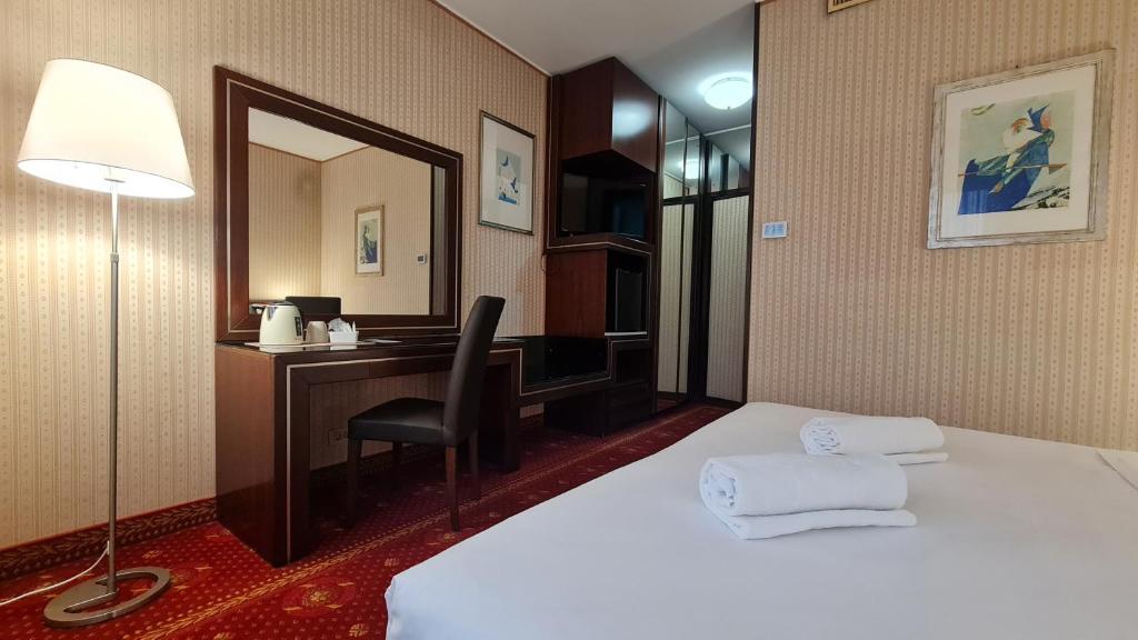 Postel nebo postele na pokoji v ubytování Garden Hotel Michelangelo