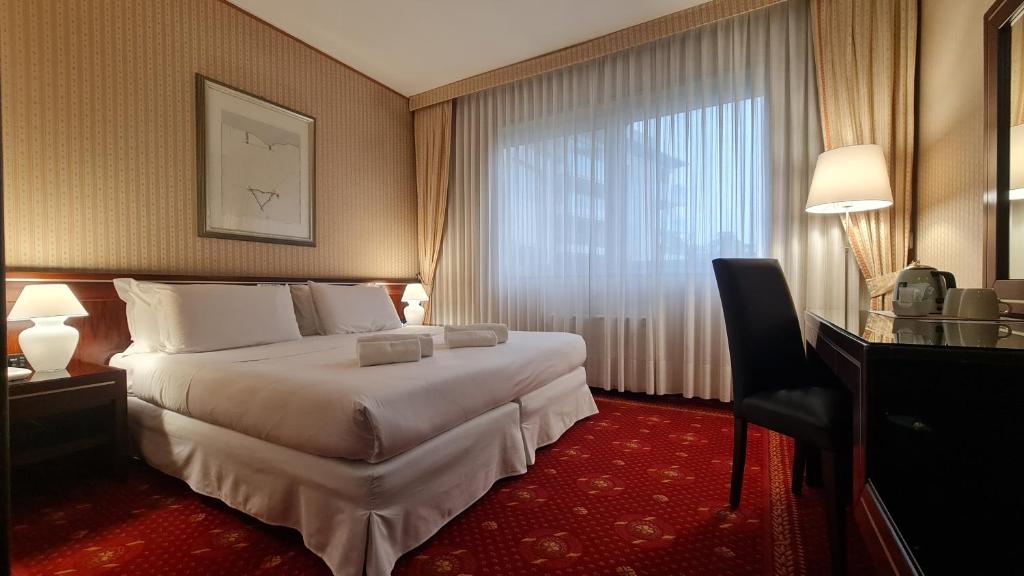 Postel nebo postele na pokoji v ubytování Garden Hotel Michelangelo