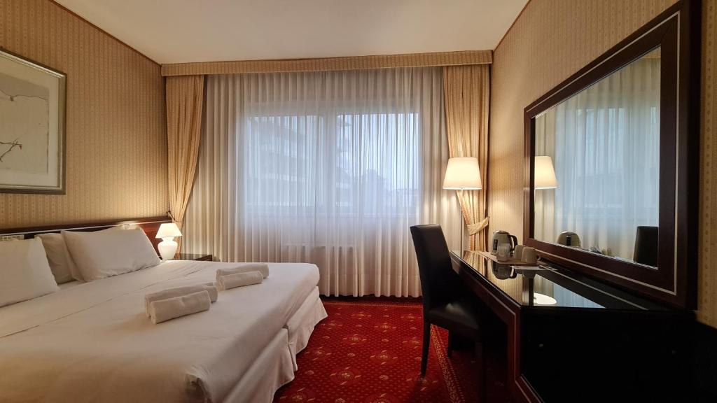 Postel nebo postele na pokoji v ubytování Garden Hotel Michelangelo
