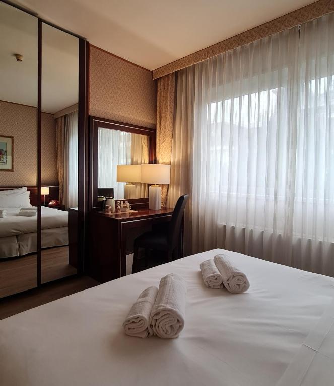 Postel nebo postele na pokoji v ubytování Garden Hotel Michelangelo