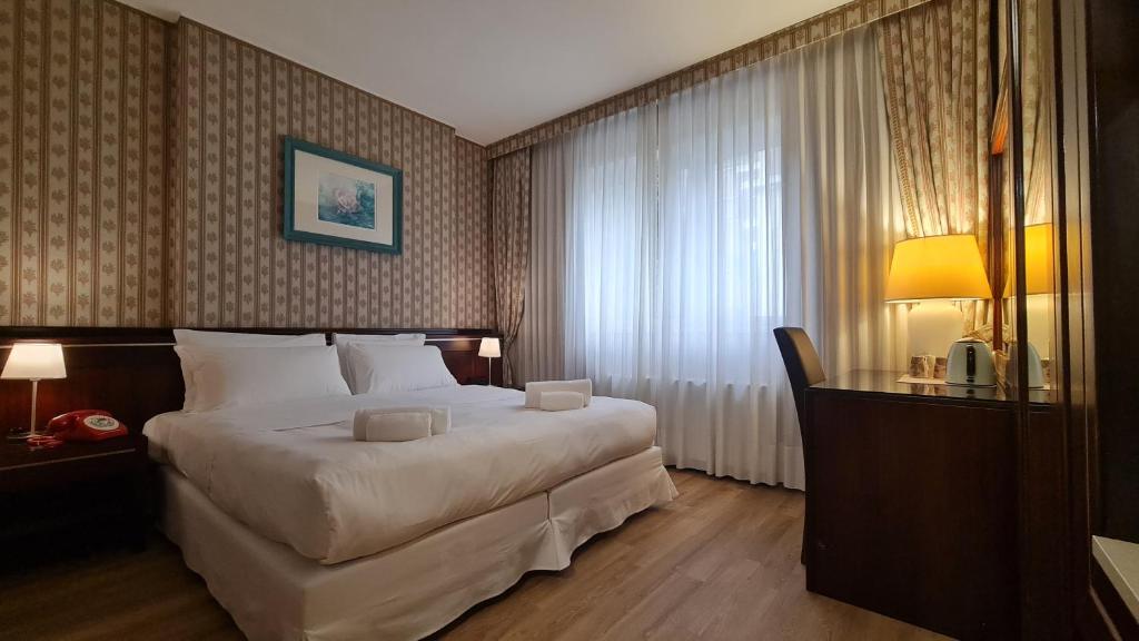 Postel nebo postele na pokoji v ubytování Garden Hotel Michelangelo