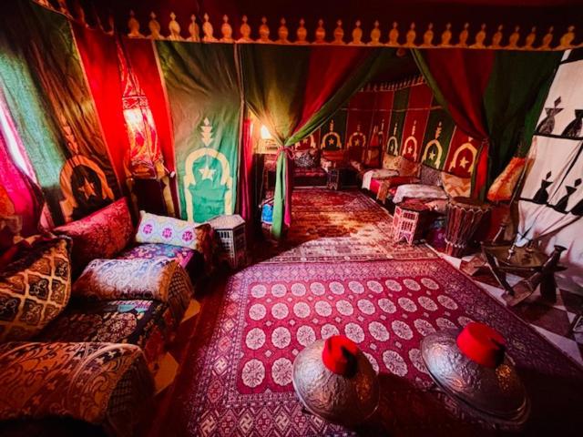 a room with many beds and chairs in a room with red at Ventana al mar , Tánger in Tangier