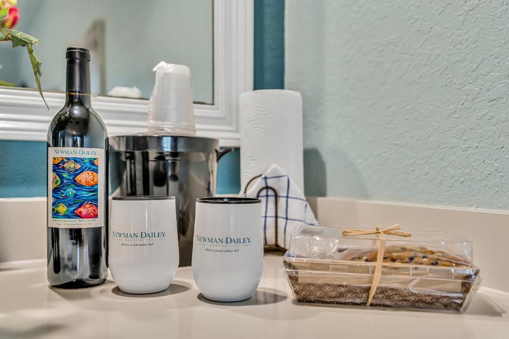 a counter with a bottle of wine and a container of food at Beachside Inn in Destin