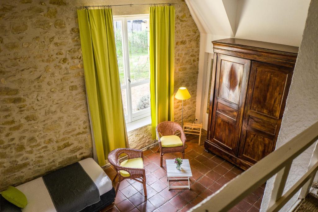 a living room with a bed and a window at Hotel La Maison des Peyrat in Sarlat-la-Canéda