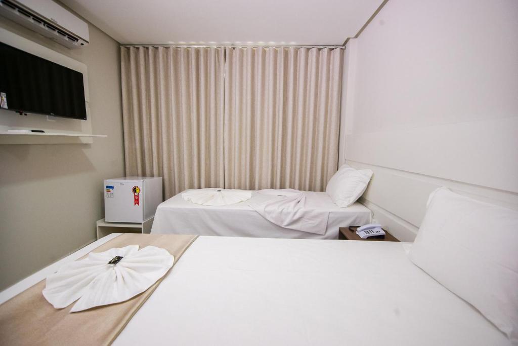 Postel nebo postele na pokoji v ubytování Hotel Portal Guanambi