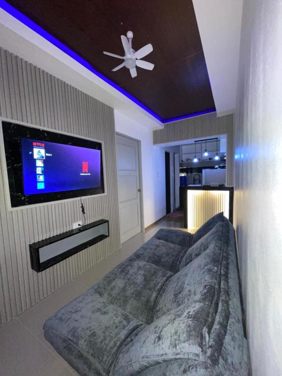 a bedroom with a large bed and a flat screen tv at The Roam Inn - Fast Wifi Connection in Dipolog