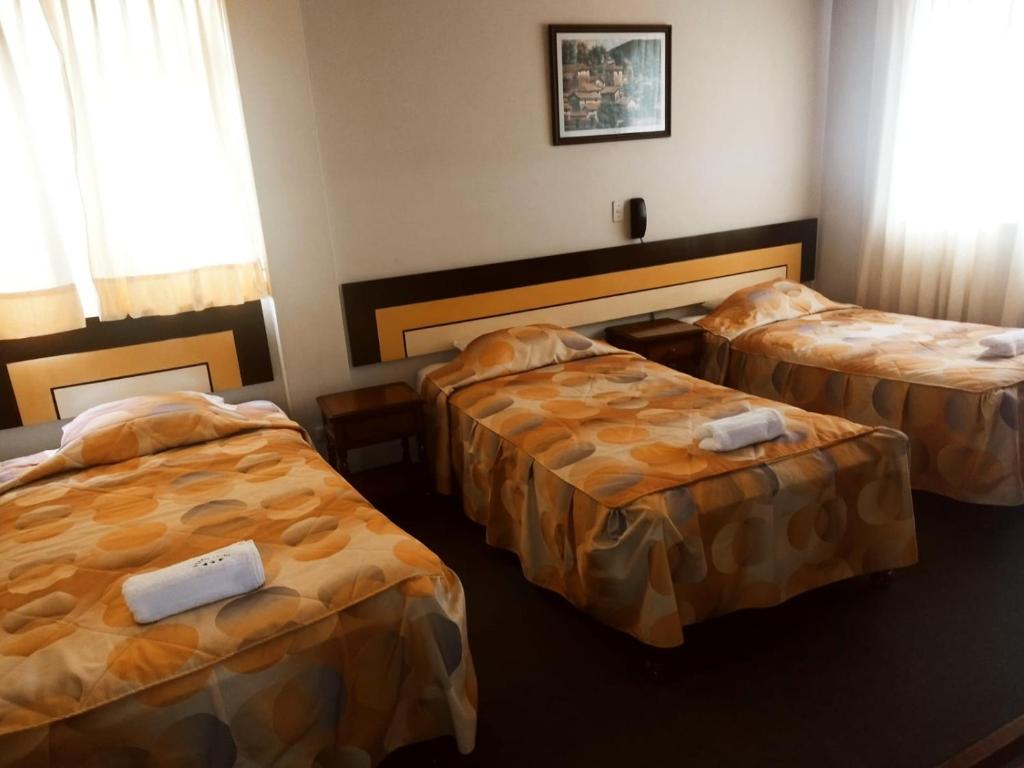 Postel nebo postele na pokoji v ubytování Hostal LATlNO