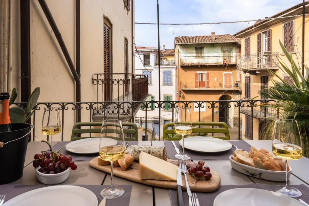 a table with food and wine glasses on a balcony at La casa sulla Terrazza in Sarnico