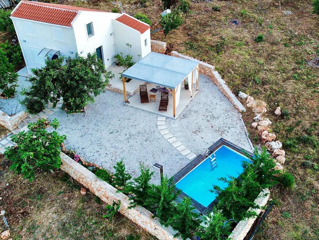 an aerial view of a small house with a swimming pool at Villa Voleonas-private pool & olive grove Chania in Kounoupidhianá