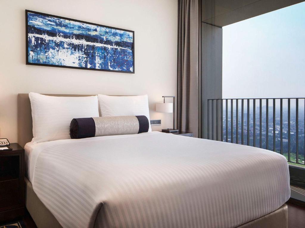 Postel nebo postele na pokoji v ubytování Fairmont Jakarta