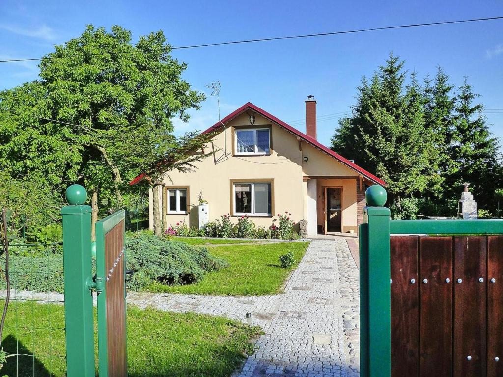 a house with a gate in front of a house at House in Wiejkowo near Szczecin Lagoon in Wiejkowo