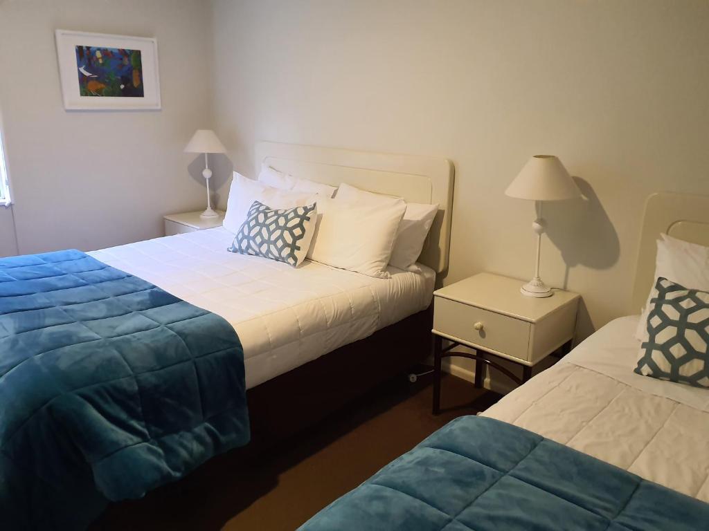 Postel nebo postele na pokoji v ubytování Tuscana Motor Lodge