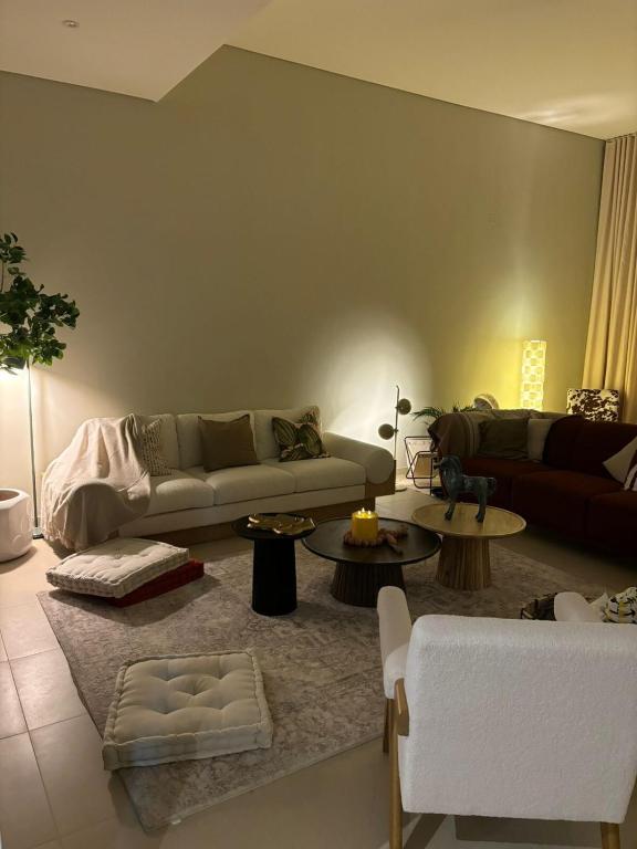 a living room with a couch and tables at Splendid Villa at Muscat Bay in Muscat