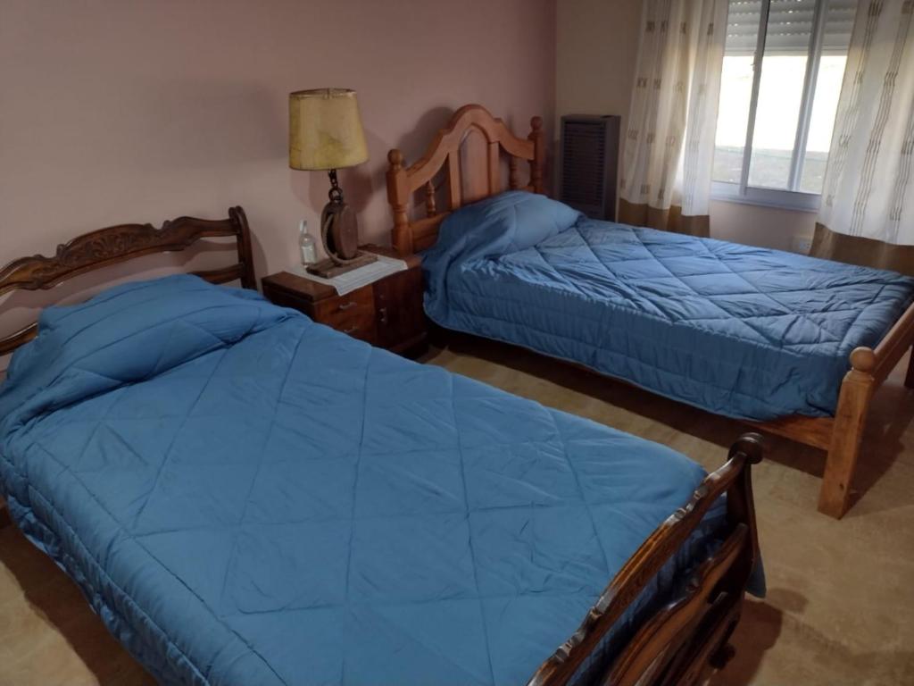 Un pat sau paturi într-o cameră la One Week Hospedaje- Hostel