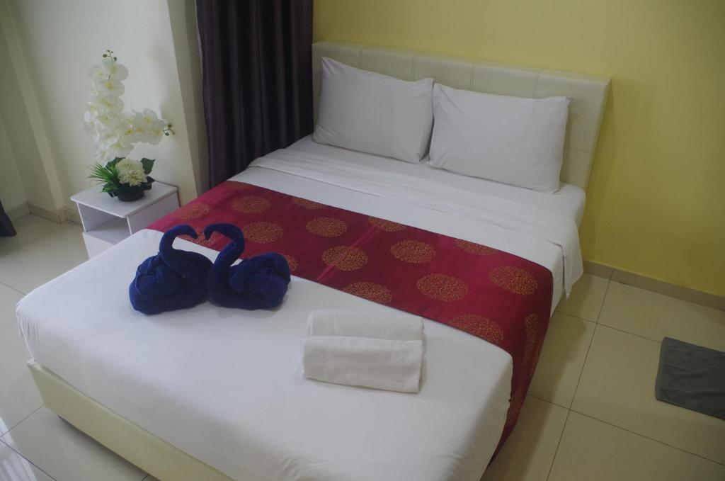 Postel nebo postele na pokoji v ubytování Hotel De Angsana
