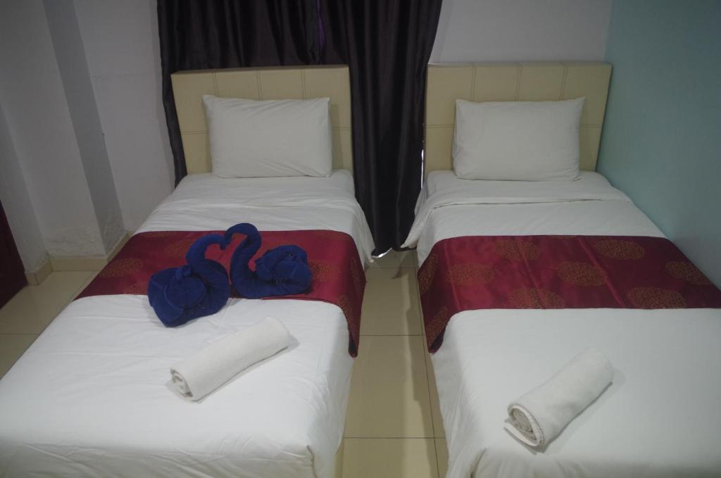 Postel nebo postele na pokoji v ubytování Hotel De Angsana