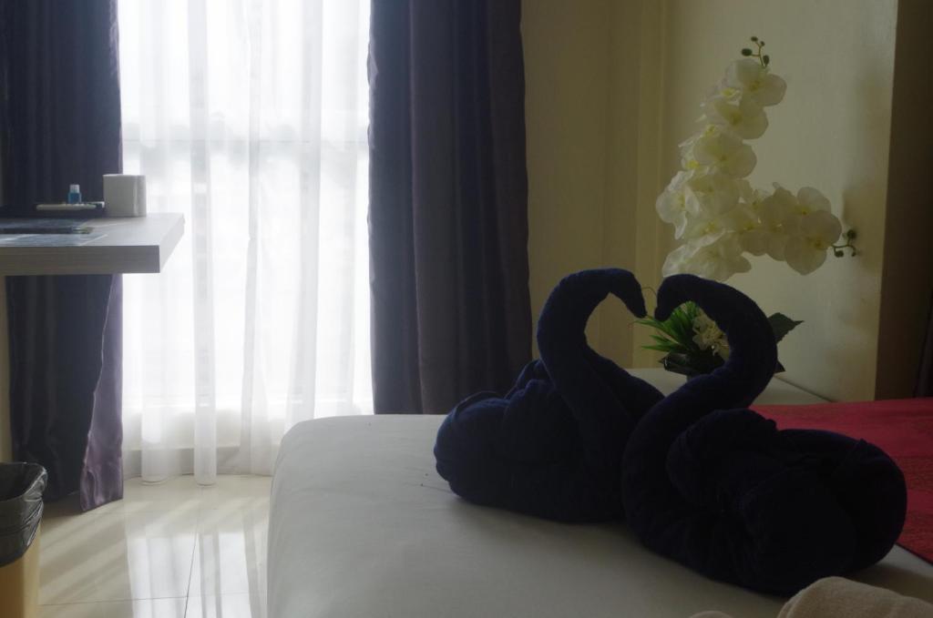 Postel nebo postele na pokoji v ubytování Hotel De Angsana