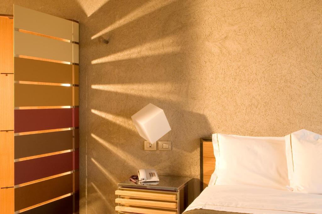 Postel nebo postele na pokoji v ubytování Albergo Cantine Ascheri