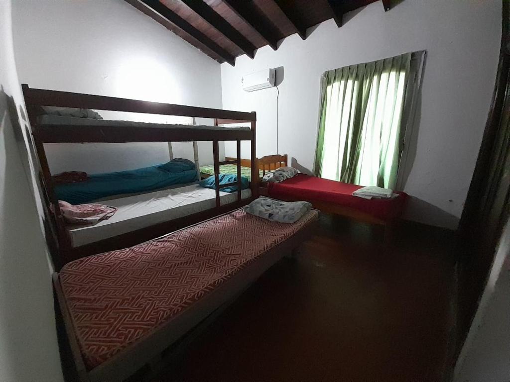 a room with two bunk beds and two windows at Quintana in Asunción