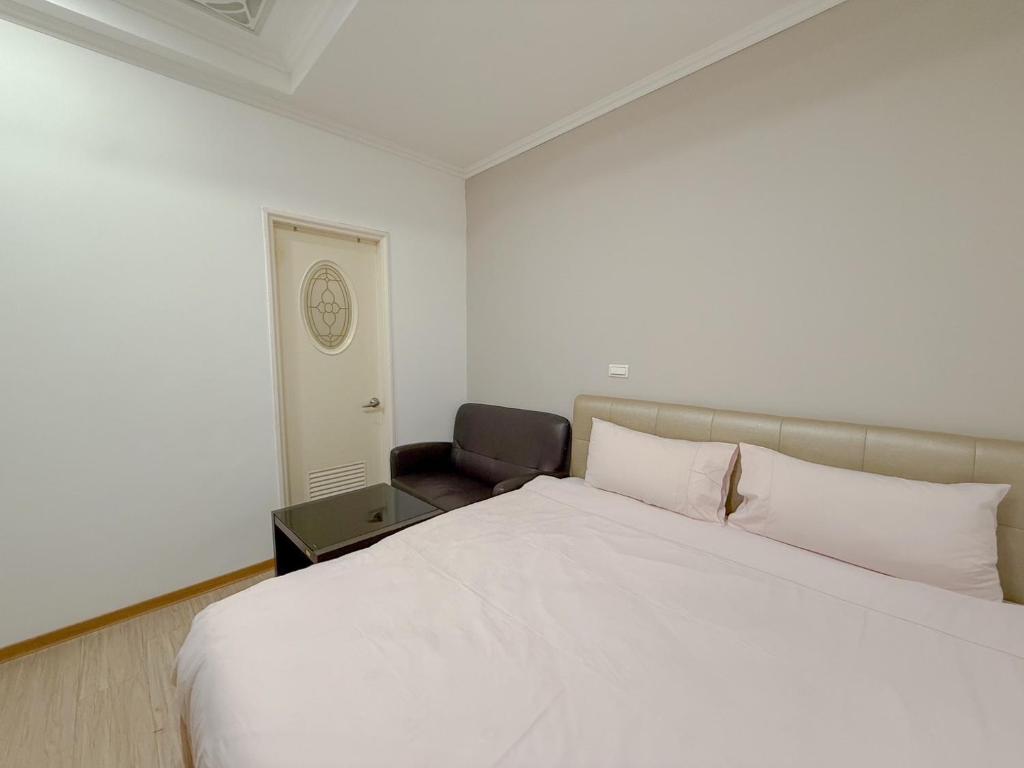 Postel nebo postele na pokoji v ubytování Tamshui Homestay