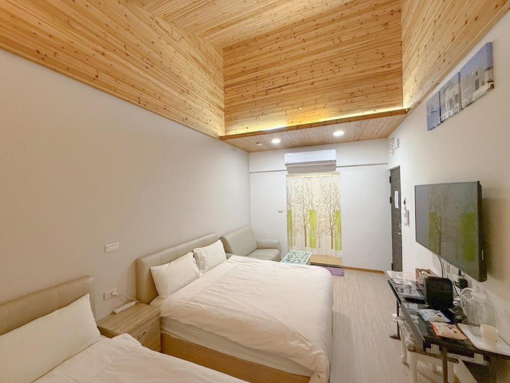 Postel nebo postele na pokoji v ubytování Tamshui Homestay