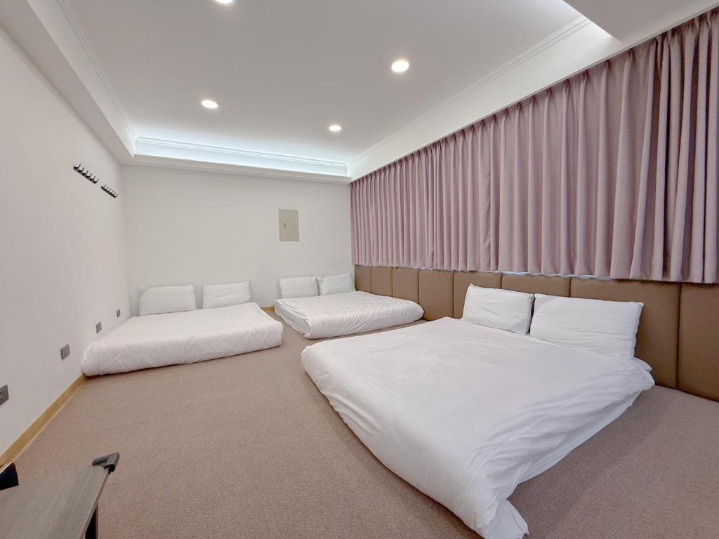 Postel nebo postele na pokoji v ubytování Tamshui Homestay