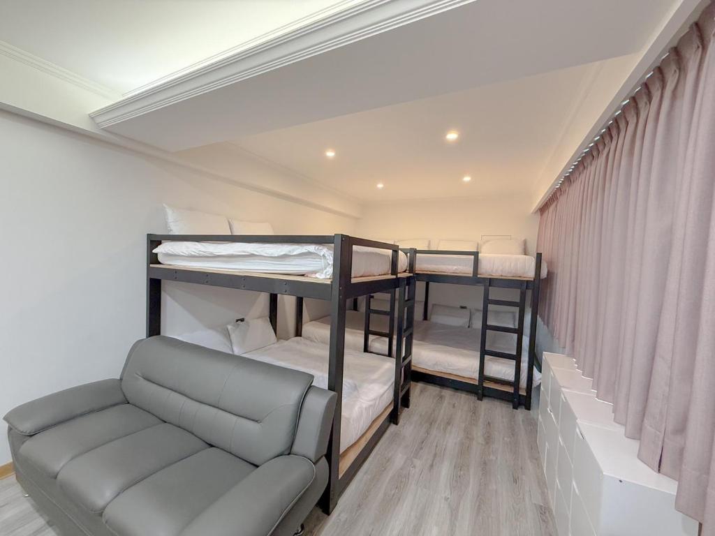 Postel nebo postele na pokoji v ubytování Tamshui Homestay