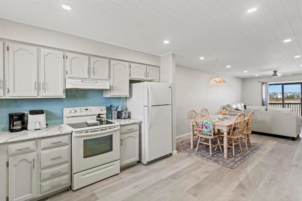 a kitchen with white appliances and a table with chairs at Jersey Shore Getaway in Seaside Heights