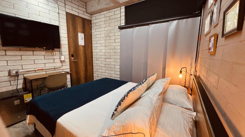 Postel nebo postele na pokoji v ubytování Manila Hotel Boutique