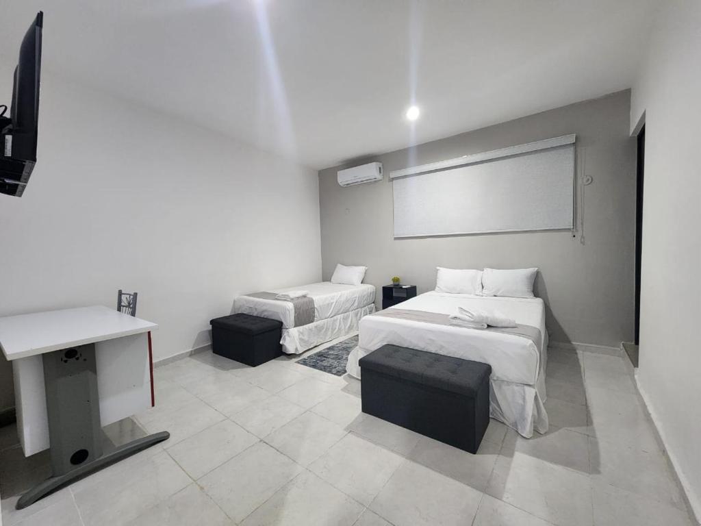 Postel nebo postele na pokoji v ubytování Hotel Suites La Maya