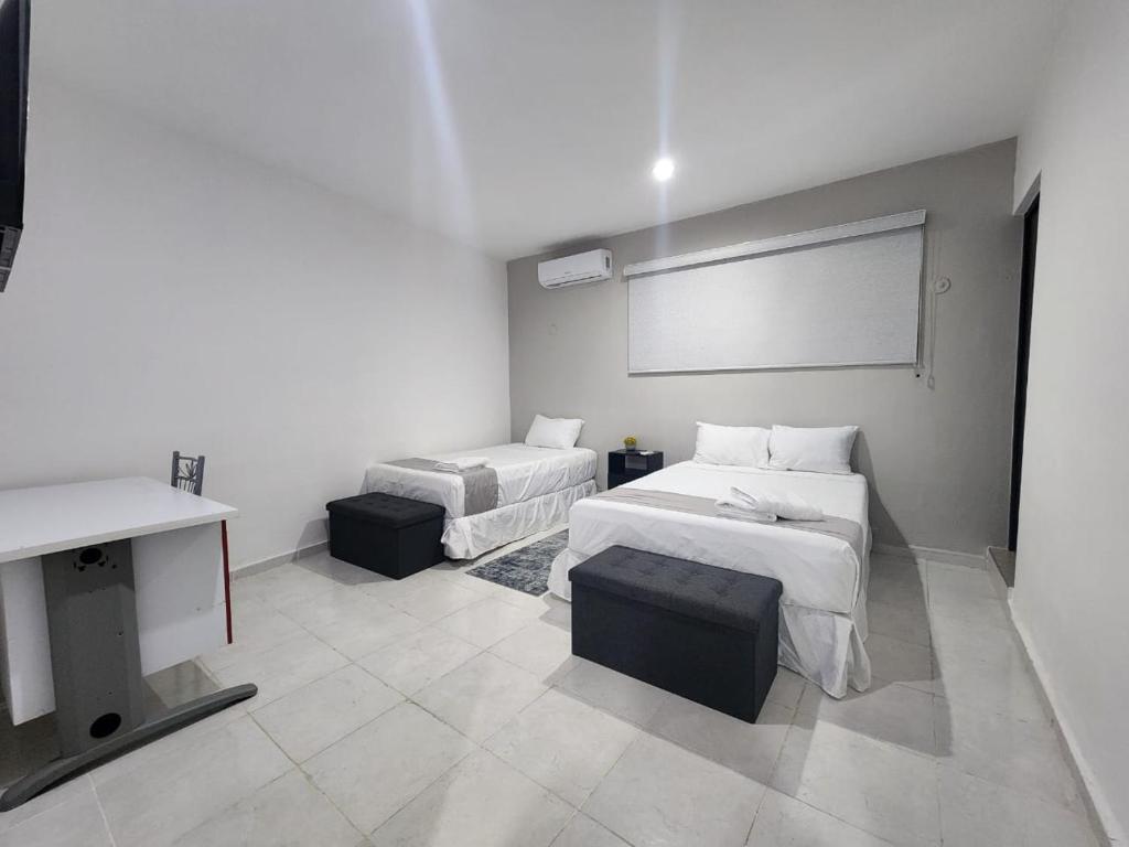 Postel nebo postele na pokoji v ubytování Hotel Suites La Maya