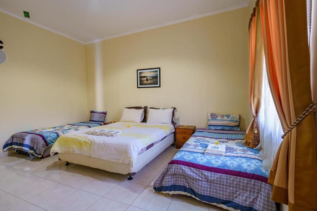 Postel nebo postele na pokoji v ubytování Whiterose Guesthouse