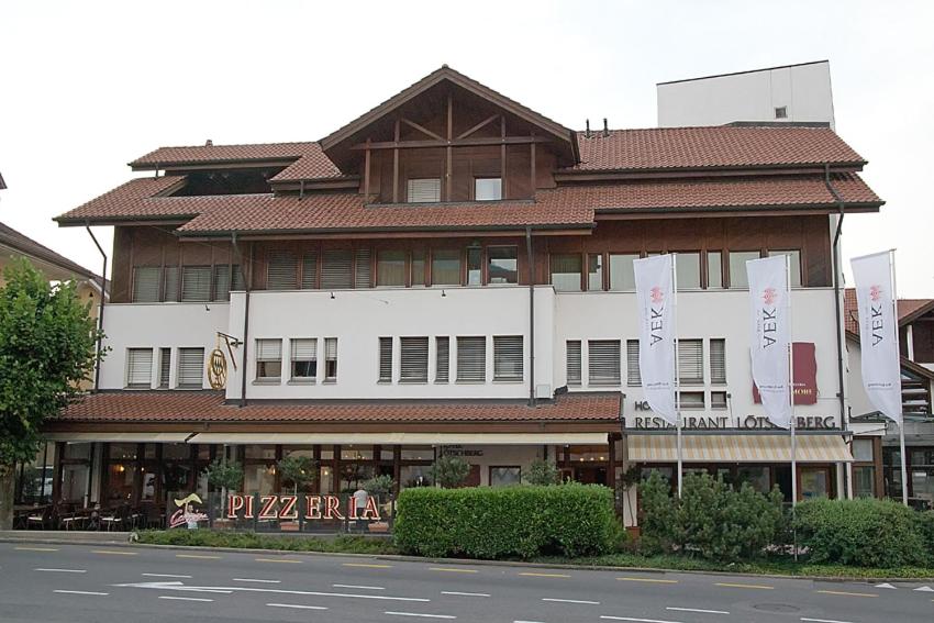 a large building on the side of a street at Hotel Lötschberg in Spiez