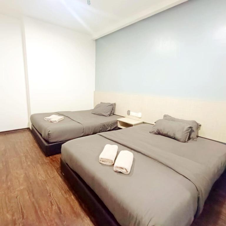 Postel nebo postele na pokoji v ubytování Rg Hotel Ayer Hitam