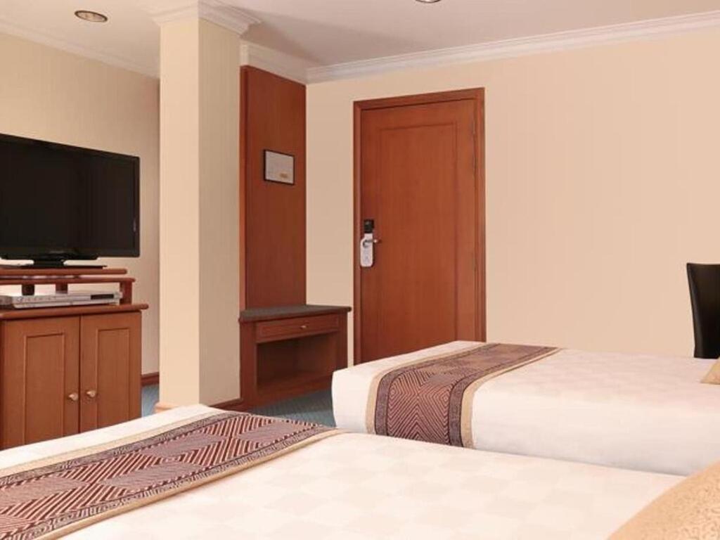 Postel nebo postele na pokoji v ubytování Hotel Sentosa