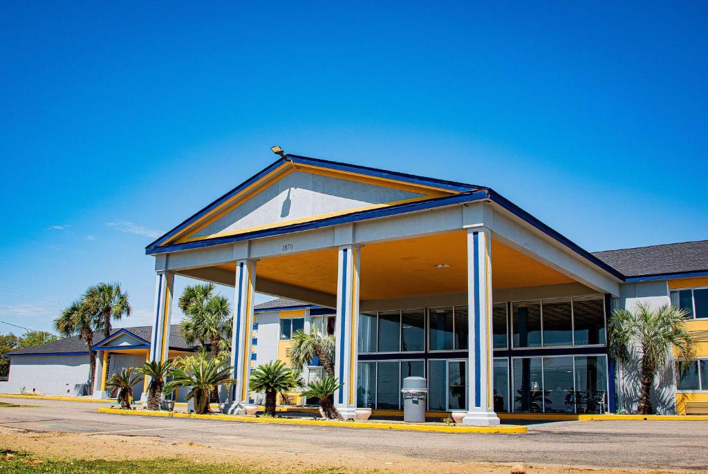 a large office building with a lot of windows at Super 8 by Wyndham Biloxi in Biloxi