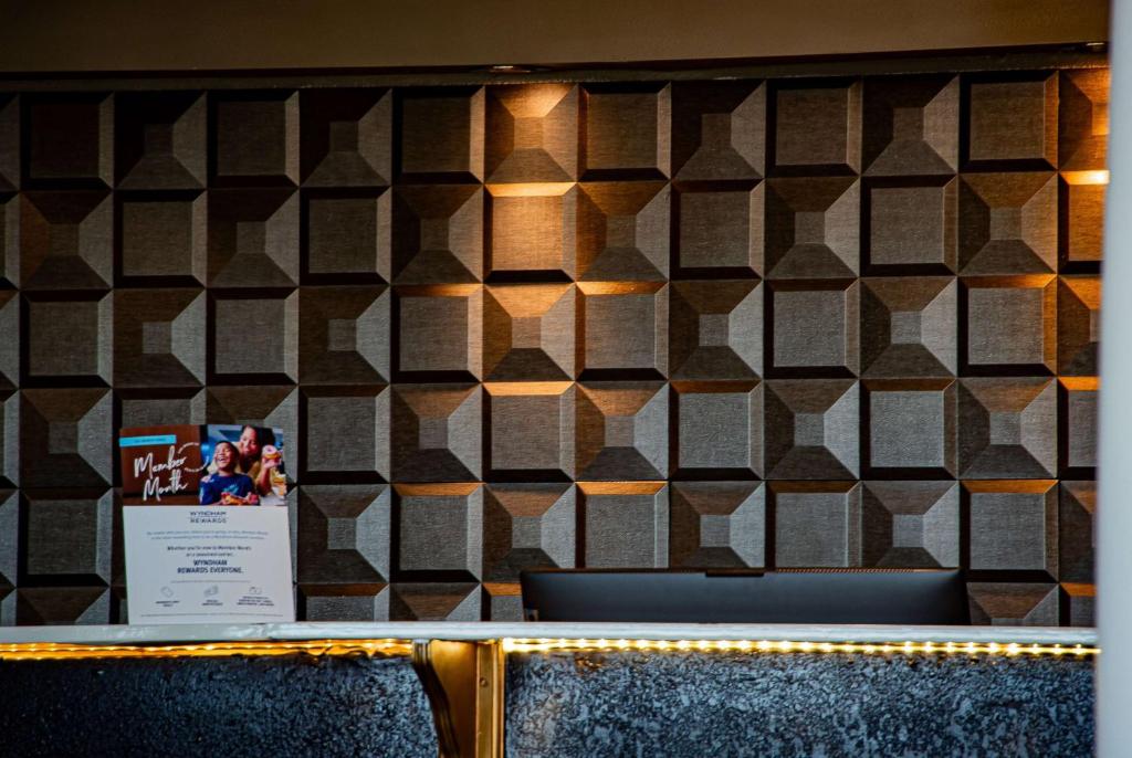 a wall with a checkered wall at Super 8 by Wyndham Biloxi in Biloxi