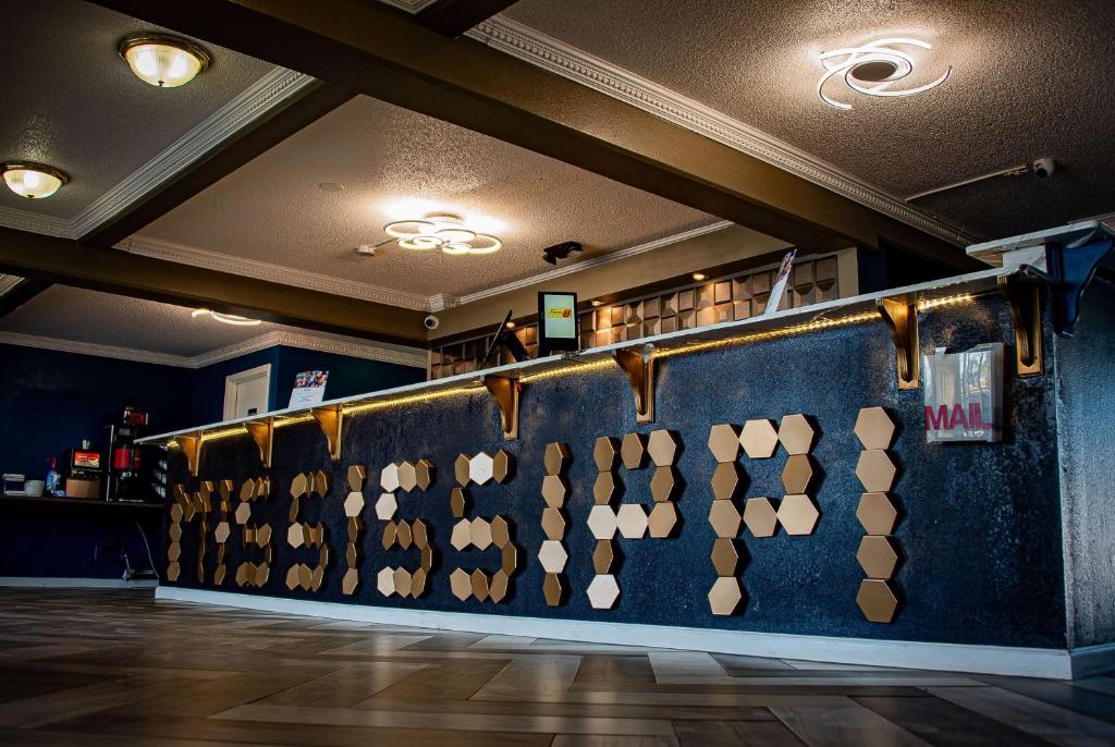 a bar with a blue wall with wooden hearts on it at Super 8 by Wyndham Biloxi in Biloxi