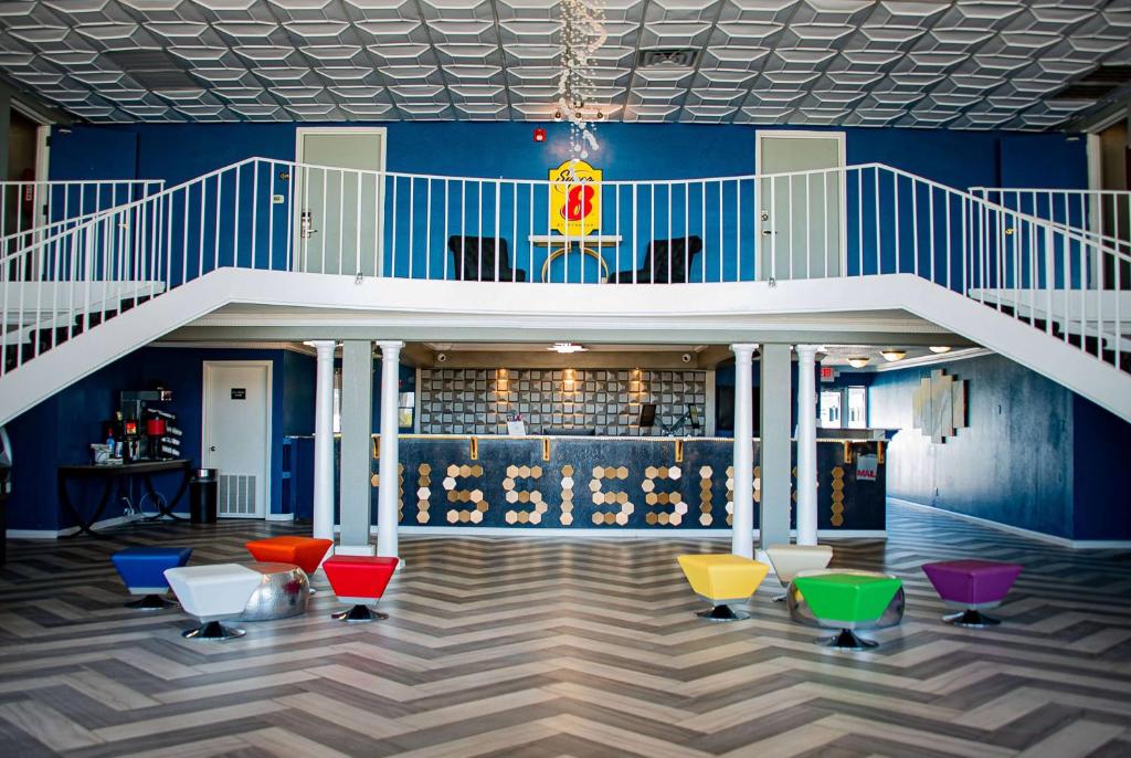 a lobby with a staircase and colorfulools at Super 8 by Wyndham Biloxi in Biloxi