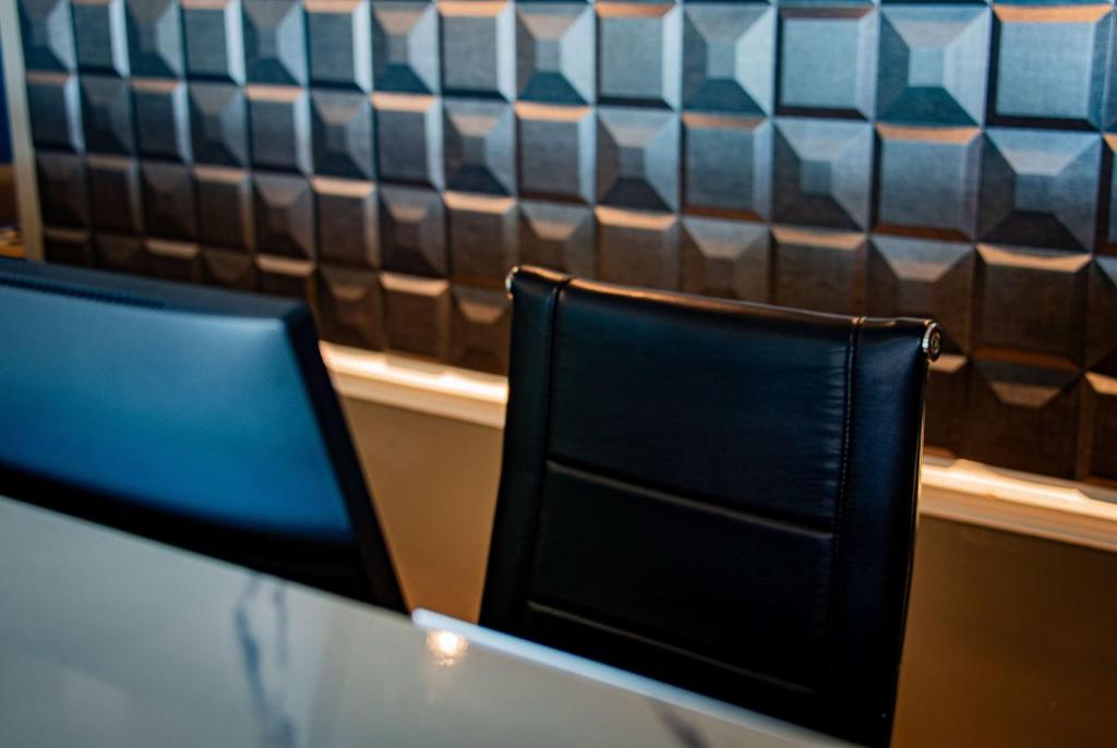 two black chairs sitting at a table in a restaurant at Super 8 by Wyndham Biloxi in Biloxi