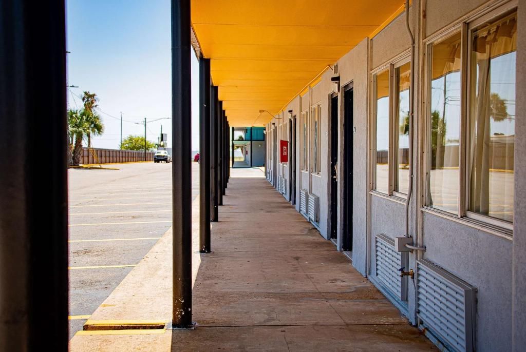 an empty hallway of a building with a yellow roof at Super 8 by Wyndham Biloxi in Biloxi