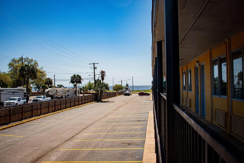 an empty street next to a building with a train at Super 8 by Wyndham Biloxi in Biloxi