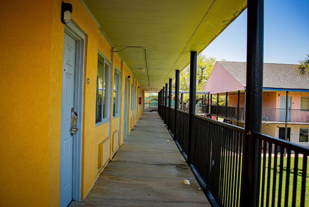 an empty hallway of a building with yellow at Super 8 by Wyndham Biloxi in Biloxi