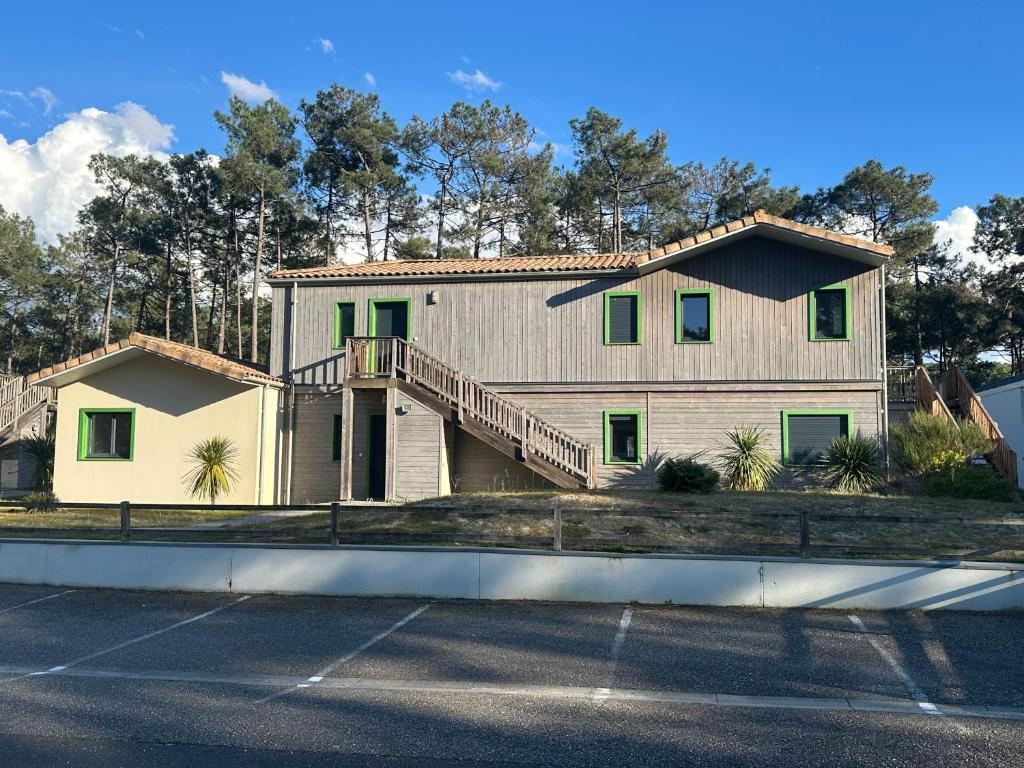 a large house with a porch and a balcony at Villa Nature in Lacanau-Océan